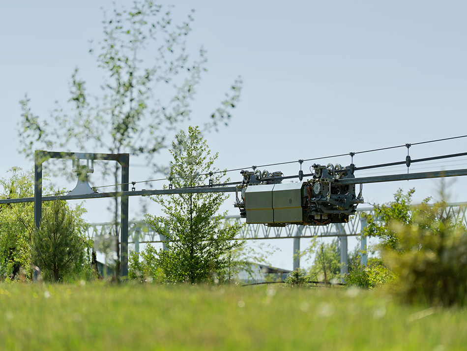 A bi-rail wheeled electric vehicle on a semi-rigid string rail overpass