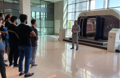 A stand with uCar (Urban Passenger uPod) designed and manufactured by UST Inc. installed at Sharjah Research Technology and Innovation Park (SRTIP)